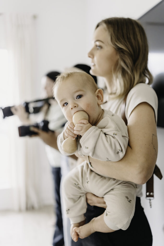 photographer holding baby at Realign retreat in Florida